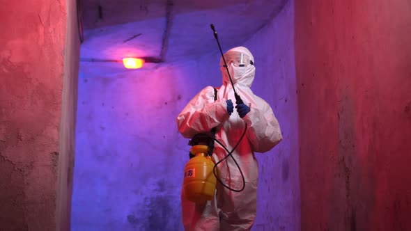 Portrait of doctor epidemiologist fighting with coronavirus. COVID-19 disinfection with atomizer.