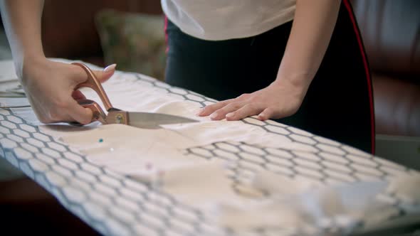 Young Woman Cutting the White Cloth Following the Soap Marks