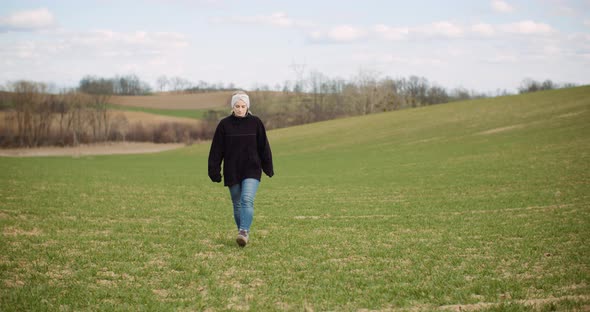 Agriculture - Female Farmer Walking on Agricultural Field