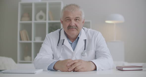 Online Appointment with Physician, Male Doctor Is Looking at Camera and Nodding Head, Video Call To