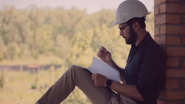 Civil Engineer Architect Construction Site. Engineer Developer In Helmet Inspecting Building.