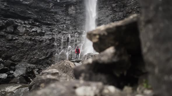 Man At Cliff Face Watching Fossa Waterfall