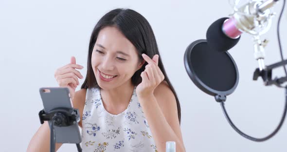 Woman having live stream on cellphone 