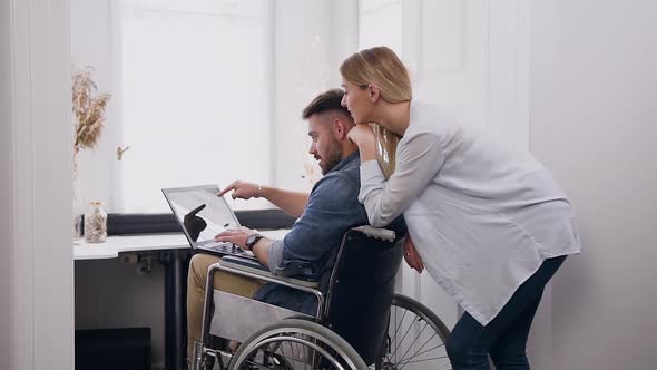 Man in Wheelchair After Accident Remotely Working at Home Under Business Project