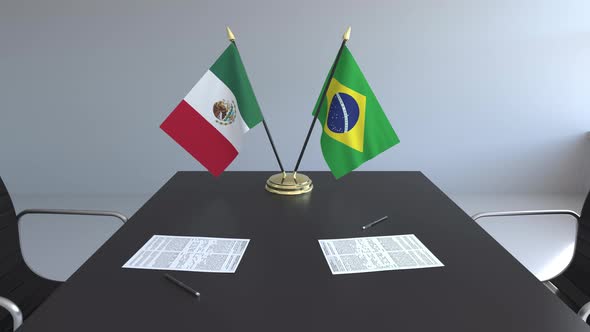 Flags of Mexico and Brazil and Papers on the Table alt