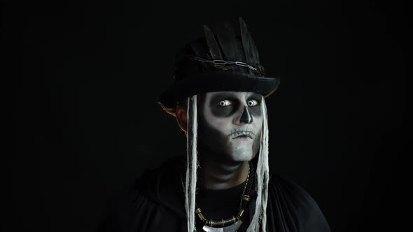 Man in Creepy Skull Makeup Constantly Looking at Camera and Shaking His Head. Halloween Costume