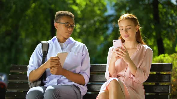 Mixed-Race Boy Trying to Get Acquainted With Gadget-Addicted Girl, She Refusing