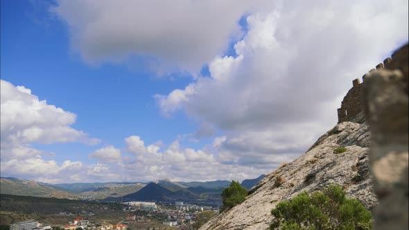 Mountains Against the Blue Sky with White Clouds. Cirrus Clouds Run Across the Blue Sky