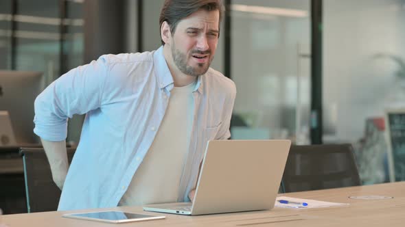 Man with Laptop Having Back Pain