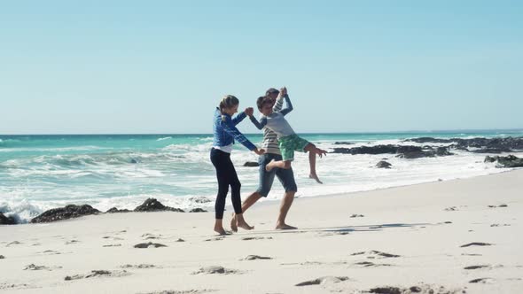 Couple and their son enjoying free time on the beach together