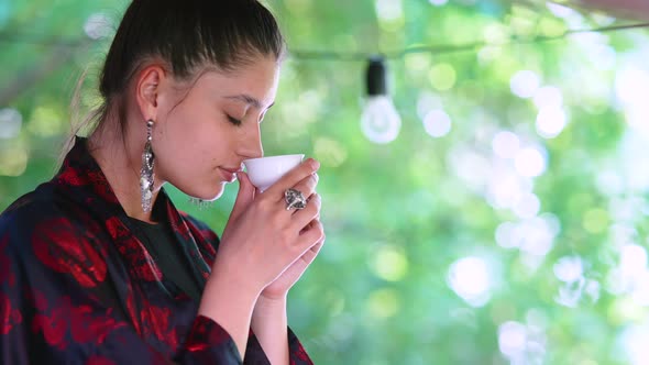 Slow Motion Shot of Woman Drinking From Tea Bowl