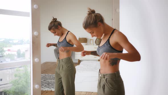 Woman is Smiling Pulling Jeans and Showing Weight Loss