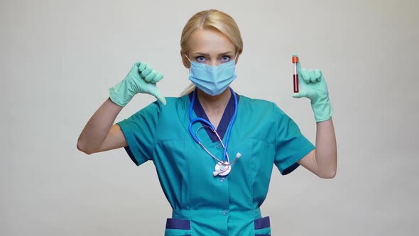 Medical Doctor Nurse Woman Wearing Protective Mask and Latex Gloves - Holding Blood Test Tube