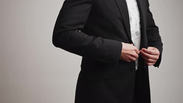 Unrecognizable Elegant Man Wearing a Formal Outfit Buttoning Up His Suit Jacket