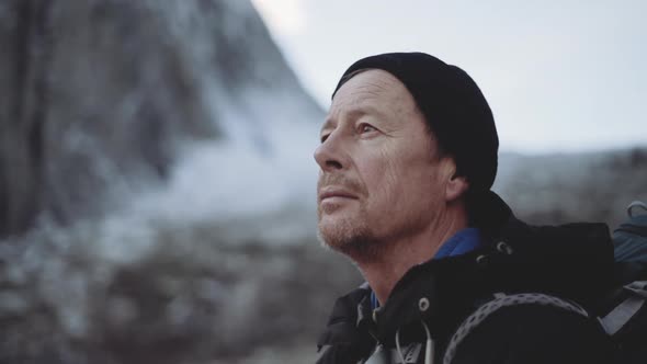 Mature Hiker Looking Around Landscape