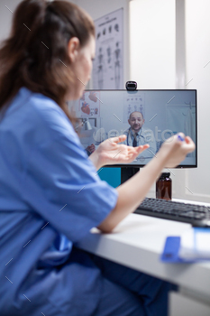 Nurse in telemedicine call with doctor