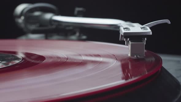 Pressing Play and Turning on the Vintage Turntable Player with Red Vinyl