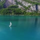 Aerial video of a sail boat cruising along Walensee Lake in Switzerland during Summer (1) - VideoHive Item for Sale