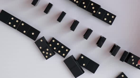 Dominoes Falling in a Row Hand Pushes a Domino and Starts a Chain Reaction Slow Motion