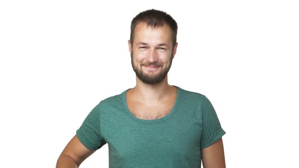 Slow Motion Horizontal Portrait of Optimistic Unshaven Man Wearing Shirt Looking on Camera Smiling