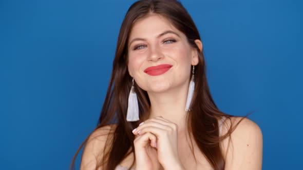 Portrait of a Girl in the Studio on a Blue Background.