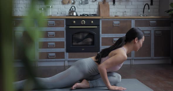 Healthy Asian Yoga Woman Practicing Stretching Pose at Home