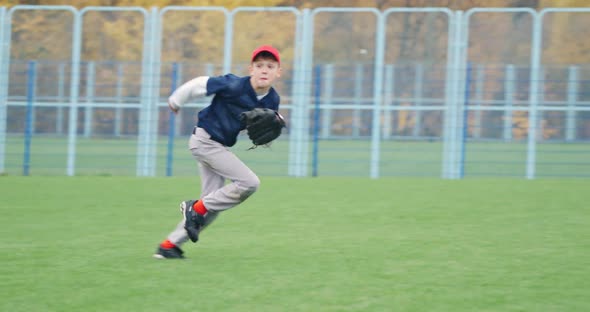 Baseball Tournament at School the Boy Pitcher Run and Successfully Catches a Fastball in the Glove