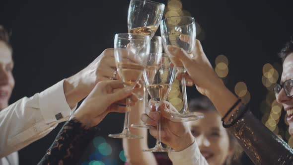 Close Up of Happy Faces of Young Friends Having Rest Together Clinking Glasses of Champagne