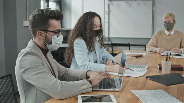 Businessman in Face Mask Working on Laptop