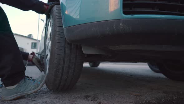 Man mounting a tyre on a car. Tyre changing process