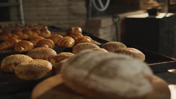 Animation of close up of fresh baked breads and rolls at bakery