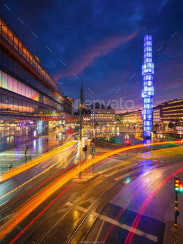 n the capital of Sweden. Public transport and blurred lights. Architectural landscape. Photo for postcards, wallpaper and backgrounds. City lighting. Bright sunset.