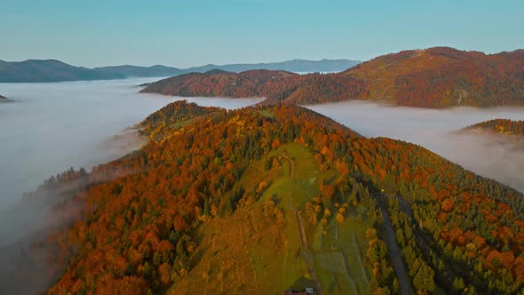 Drone Flight at Sunrise Over Beautiful Autumn Landscape of Mountain Range with Sea of Clouds in