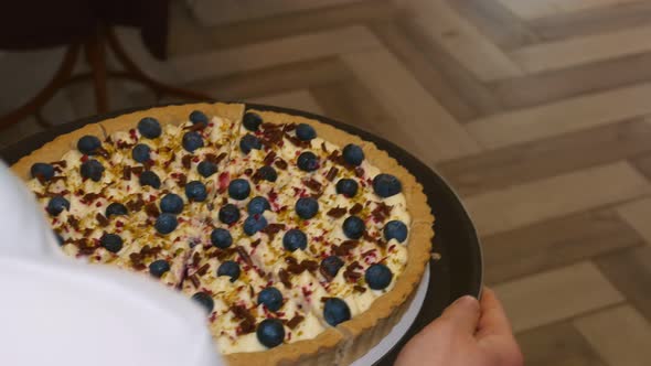 Sliced Berry Pie is Laid Out on a Round Dark Brown Tray