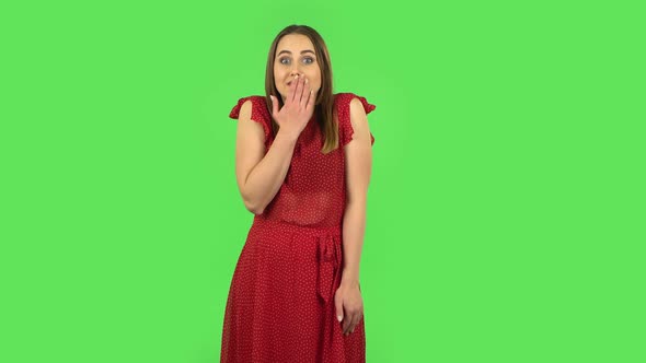 Tender Confused Girl in Red Dress Is Saying Oops and Shrugging. Green Screen
