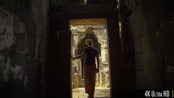 4K Following Back of Woman Walk Through an Ancient Doorway in Angkor Wat