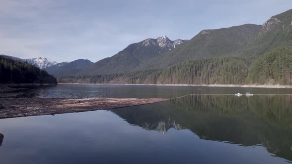 Cleavland dam on Capilano lake with Lions peaks in background, North Vancouver in Canada. Aerial for