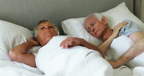 Senior couple sleeping in the bedroom