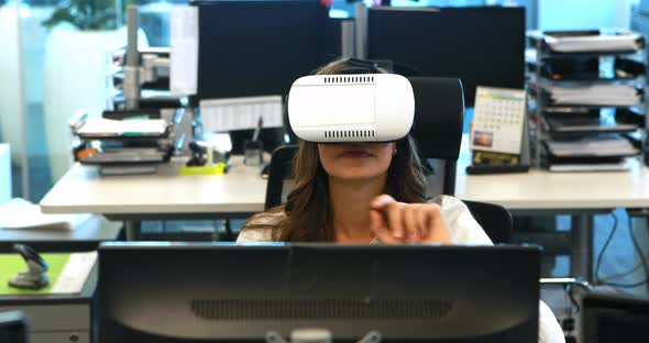 Female executive using virtual reality headset