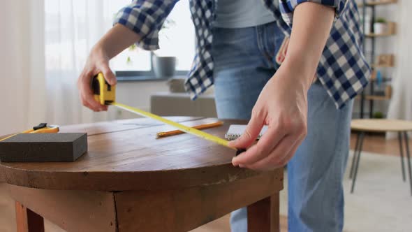 Woman with Ruler Measuring Table for Renovation