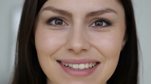 Close Up of Smiling Face of Young Woman Looking at Camera