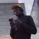 Portrait of Stylish Young African American Tourist Listening to Music Using Headphones and Smart - VideoHive Item for Sale