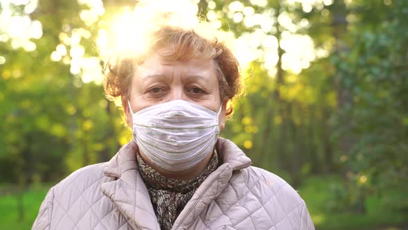 Mature Woman in Mask in Park