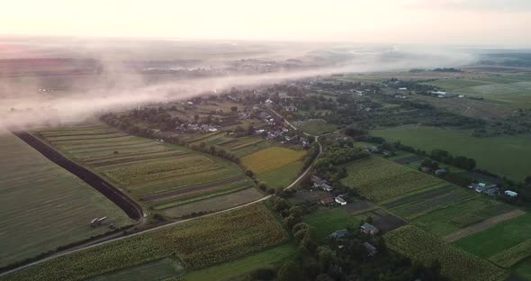 Sunrise and Morning Fog Over the Countryside
