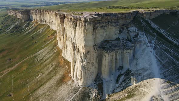 White Vertical Rocky Wall Rising Above the Valley