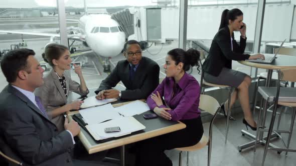 Business people having meeting at airport