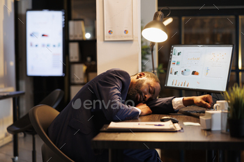  office, workaholic employee falling asleep because of overtime work. Drained african american businessman with burnout syndrome resting at work.