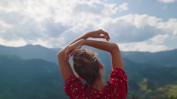 Girl Standing Raising Hands in Mountains Close Up