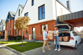 m a car and carries them to a new home. Renting and buying a home. Moving concept.