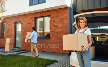 m a car and carries them to a new home. Renting and buying a home. Moving concept.
